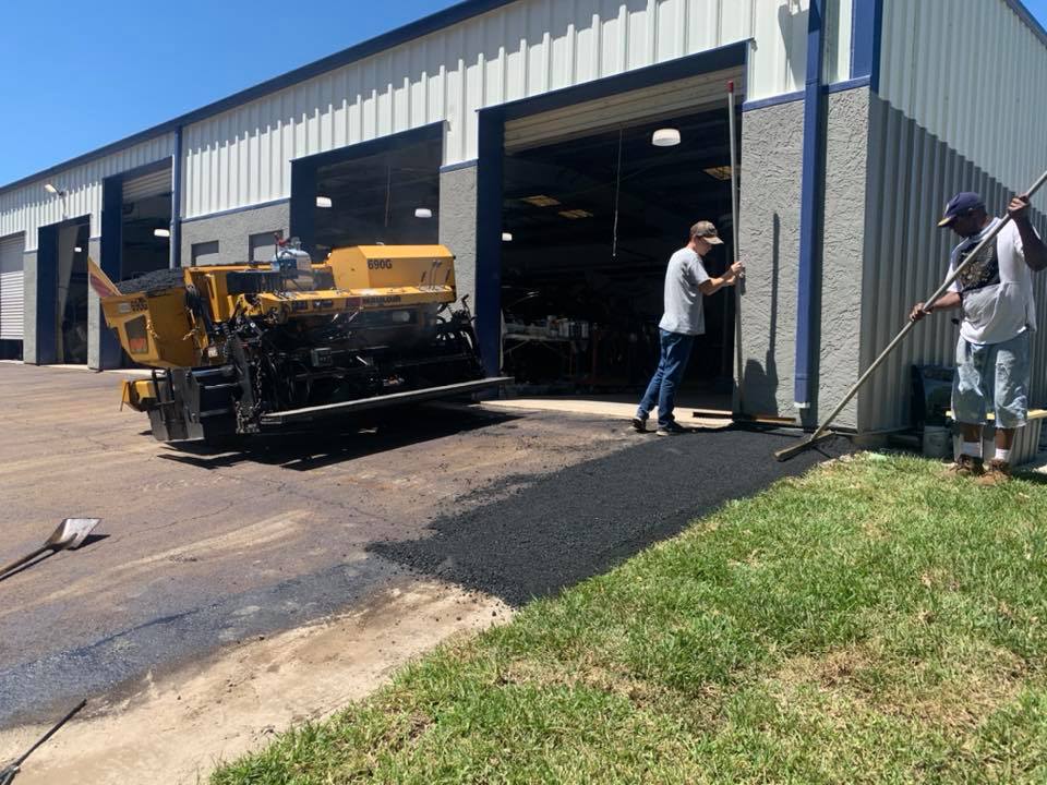 A. Rafferty Paving team sealcoating a residential driveway