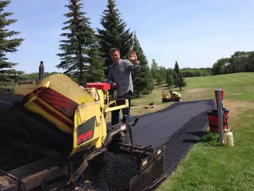 Man working an asphalt equipment for paving