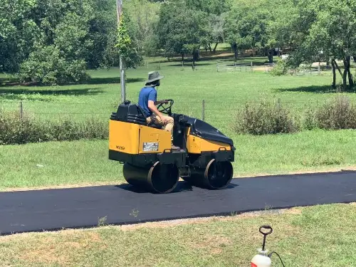 Man driving an asphalt compactor