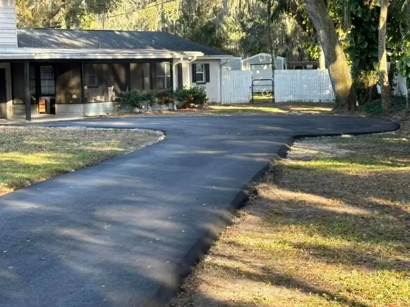 A newly paved residential asphalt driveway